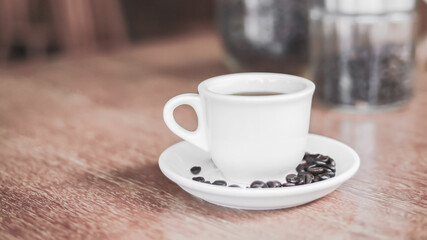 Hot coffee americano on the old wooden table.