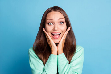 Photo portrait of surprised girl touching face cheeks with two hands with wide open eyes mouth isolated on pastel blue colored background