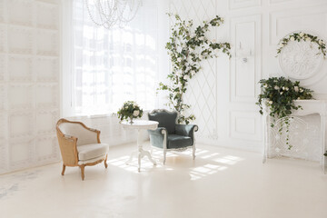 luxury delicate interior of the living room and bedroom in light colors with expensive chic carved furniture in classic style