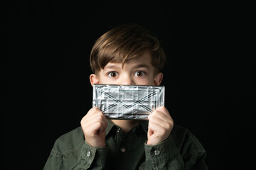  little boy holds a chocolate bar in foil