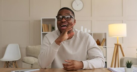 African American man speaking on video call at office - Powered by Adobe