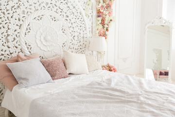 luxury delicate interior of the living room and bedroom in light colors with expensive chic carved furniture in classic style