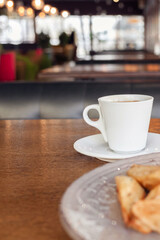 Breakfast, dinner, lunch in a restaurant, cafe. Baked potatoes with meatballs, caesar salad, Coffee Americano. intervier, delicious food, large windows, natural sunlight. Blurred background