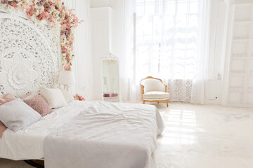 luxury delicate interior of the living room and bedroom in light colors with expensive chic carved furniture in classic style