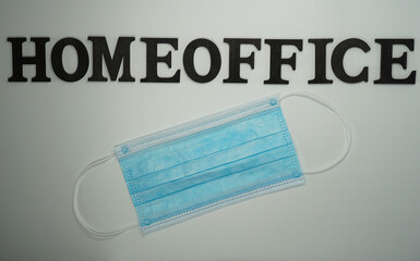 the word home office with a mask in front of a white background   