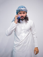 Religious man watching social media in the smart phone isolated on a grey background