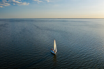 Yacht sailing at sunset. Luxury vacation at sea.