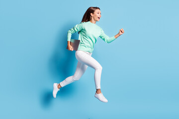Fototapeta na wymiar Profile photo of shiny cute girl wear casual outfit white pants hurrying running holding e-book gadget isolated blue color background