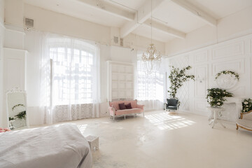 luxury delicate interior of the living room and bedroom in light colors with expensive chic carved furniture in classic style