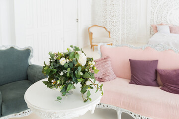 luxury delicate interior of the living room and bedroom in light colors with expensive chic carved furniture in classic style