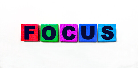 The word FOCUS is written on colorful cubes on a light background