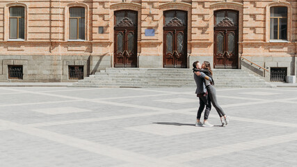 Valentines day celebration and dating outdoor concept. Happy loving couple dancing on the city street. Romantic couple spending time together in the city