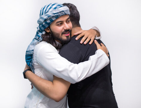 Muslims Hug With Each Other After Eid Prayer, Muslim Arabic Brothers Meeting Together With Father, Muslim Man Hugging And Wishing To Each Other On Occasion