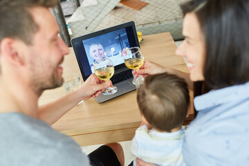 Couple celebrating birthday and drinking wine in video chat