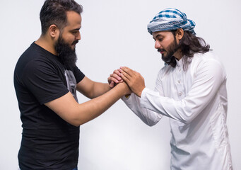 Successful Arabic business people shaking hands over a deal