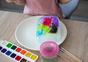 Child painting an ice, sensory activity, DIY.
