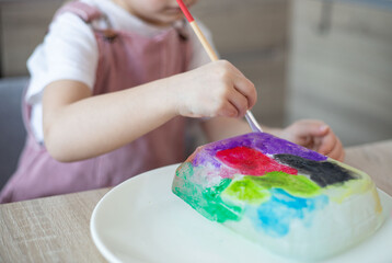 Child painting an ice, sensory activity, DIY.