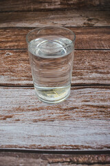 glass of water on wooden table