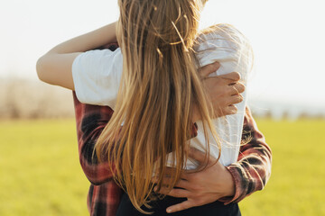 Cropped view of a couple hugging passionately at nature. Close up.