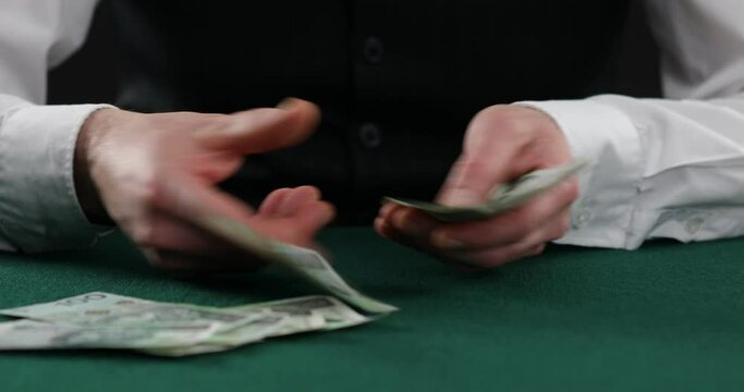 man counting Polish Zloty on table . A man in a business shirt is counting Polish money. man hands count Polish banknotes.