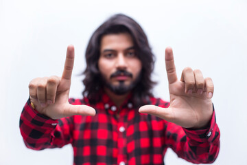 Close-up portrait of a young man focusing object. Stress-free. Human facial expression, emotion, feeling, sign symbol body language