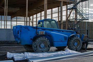 Vendée, France; January 24, 2021: a blue telescopic cart on the construction site of the future sports hall of the Saint Gilles Croix de Vie high school.