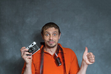 a European man with a film camera in his hands. Photographer with an analog camera and photographic...
