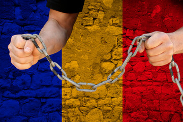 male hands breaking the iron chain, symbol of tyranny, protest against the background of the...