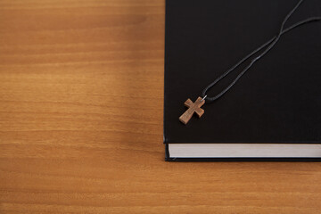 Holy Bible with a wooden cross.