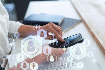 HR woman specialist in formal wear browsing social networks in the Internet in smart phone to find the best candidates to hire international team. Concept of success. Media hologram icons.