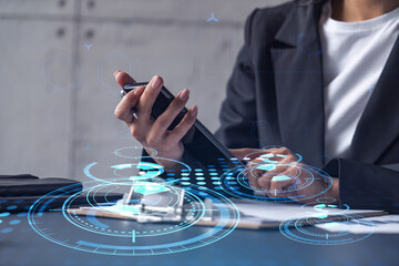 Businesswoman in formal wear checking the phone to sign the contract to create a software to present it at start up conference and gain investments for innovative service. Hologram tech graphs.
