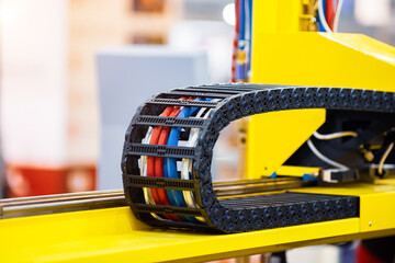 Plastic cable chain of electrical wires in the machine