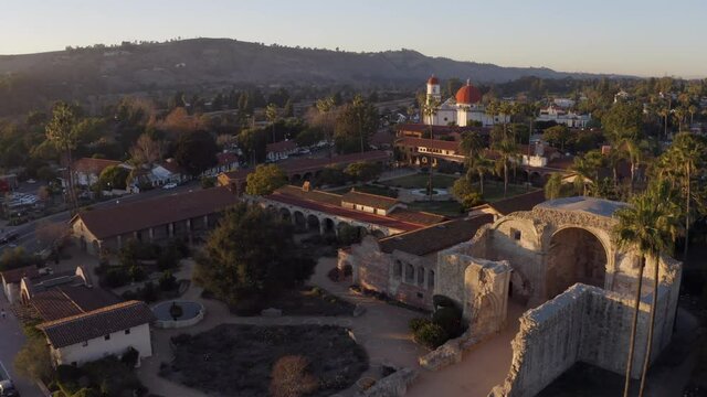 Sunset aerial view of the Spanish Colonial era mission and surrounding city of downtown San Juan Capistrano, California, USA. 