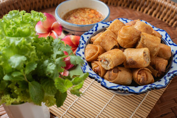 Deep fried spring roll on the wooden table. 