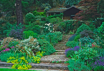 Steps leading up sloping garden to a Country House