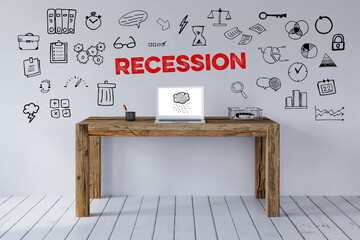 Schriftzug Recession über Schreibtisch