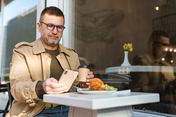 Young man texting message on smart phone