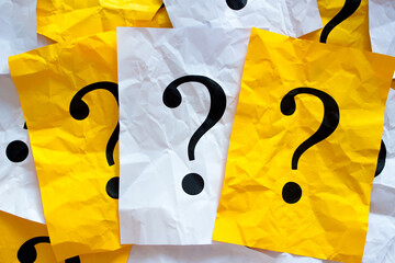 Black question marks on the colored papers