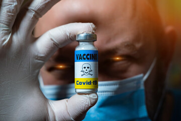 The dangers of coronavirus vaccination. Harmful side effects concept. A devilish doctor holds a...