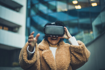 Women testing Virtual Reality simulator on the street.