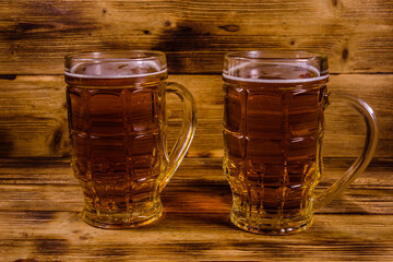 Two glasses of beer on wooden table