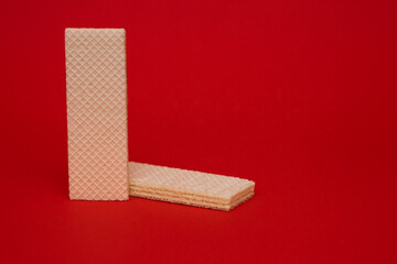 Wafer cookies on a red background. Delicious sweet dessert for coffee or tea
