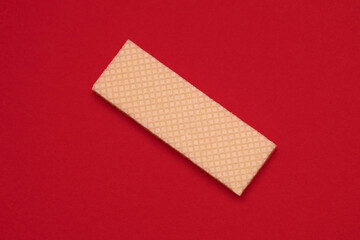 Wafer cookies on a red background top view