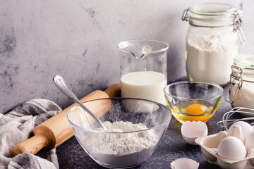 Fototapeta na wymiar Cooking ingredients for dough, eggs, flour, sugar, milk.