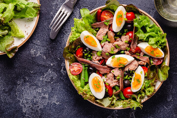 salad Nicoise with tuna, eggs, green beans, tomatoes,  olives, lettuce and anchovies