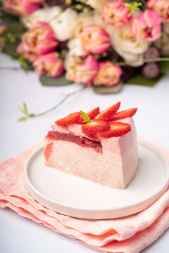 Delicious handmade strawberry frozen gradient colour cake slice with strawberries Strawberry cake with flowers on the table for Valentin's day or birthday party. Withe background. High quality photo