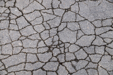 gray texture of cracked asphalt for background