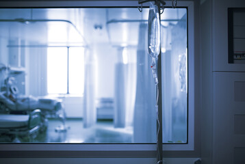 Ward behind the glass viewing window in the hospital hallway, unfocused background