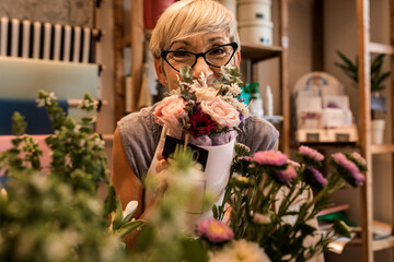 Portrait of senior female florist in her flower shop.