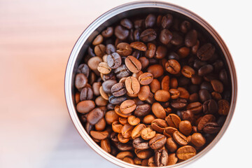 .Roasted coffee beans in a bowl, top view